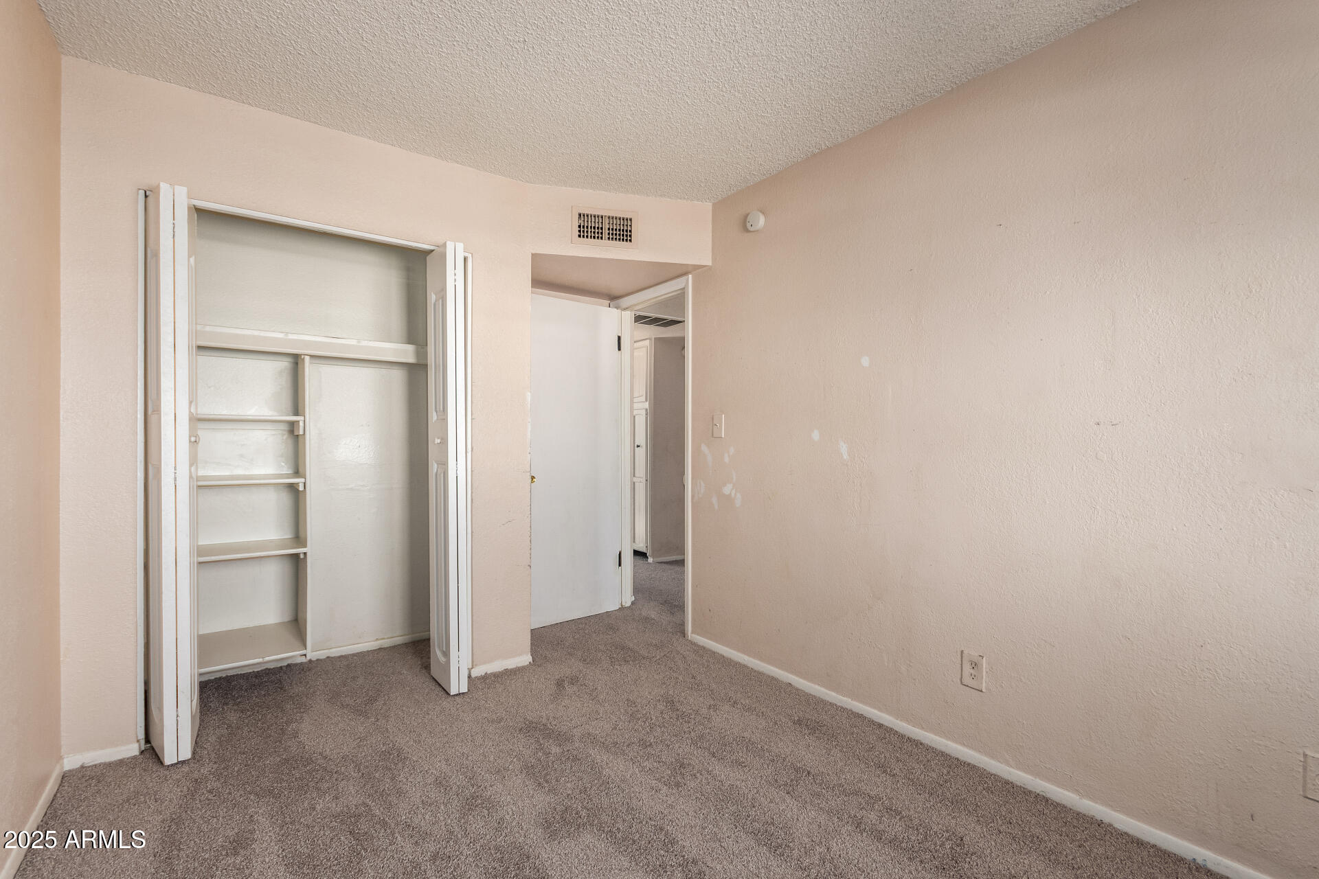 4625 West Thomas Road, Unit 43 Phoenix, AZ 85031 - Photo 17 of 26 an empty room with closet and closet