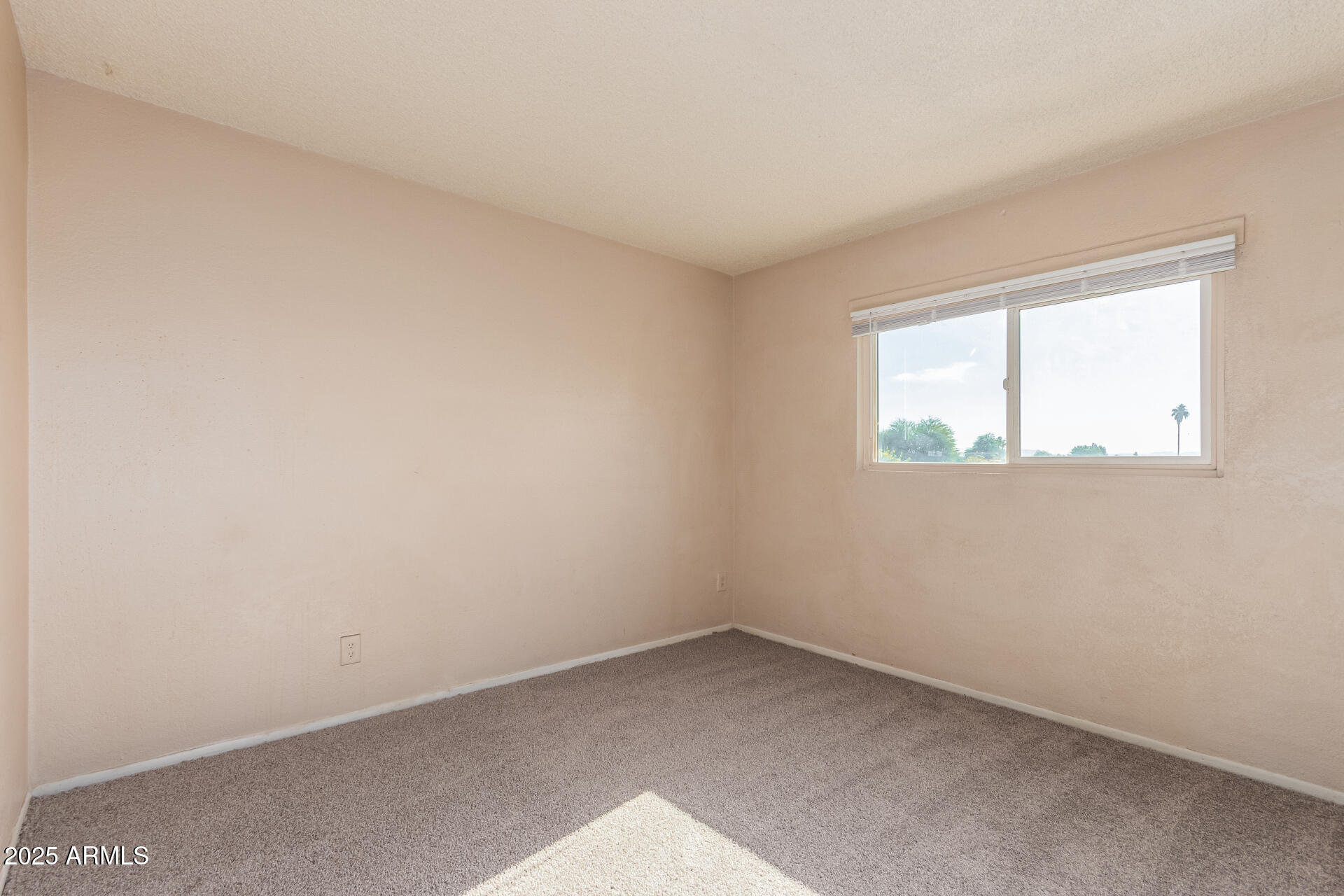 4625 West Thomas Road, Unit 43 Phoenix, AZ 85031 - Photo 19 of 26 an empty room with a window
