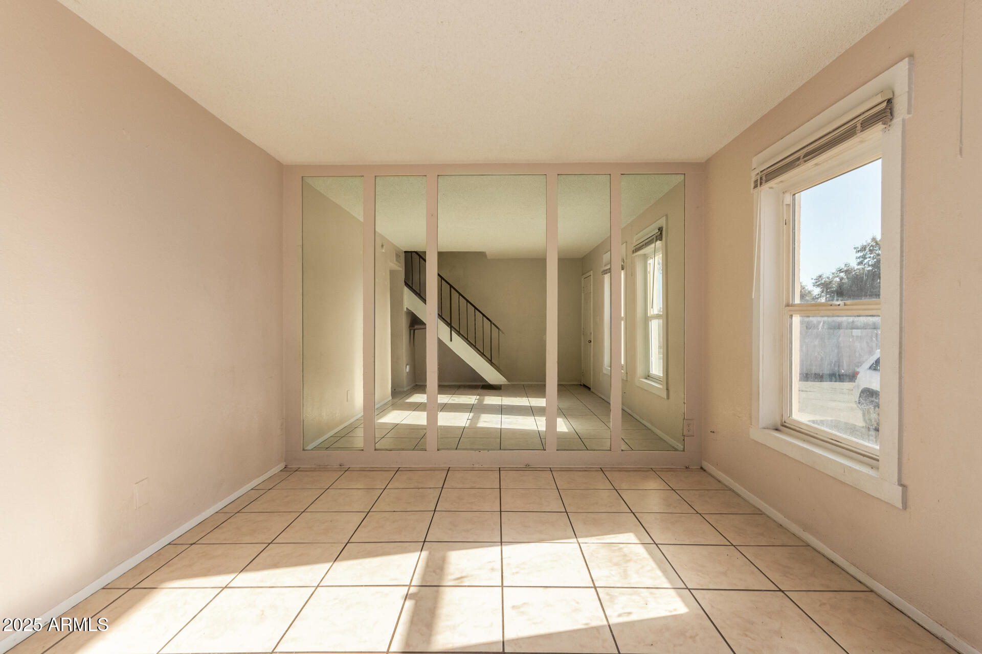 4625 West Thomas Road, Unit 43 Phoenix, AZ 85031 - Photo 6 of 26 a view of an empty room with a window