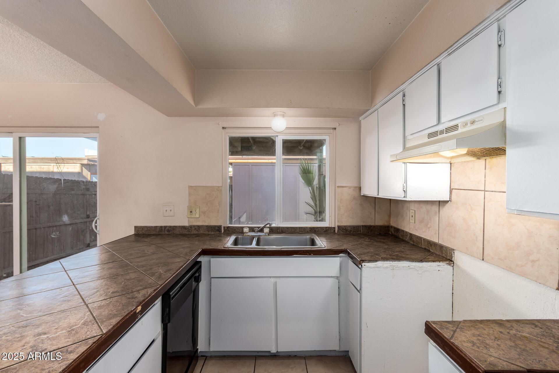 4625 West Thomas Road, Unit 43 Phoenix, AZ 85031 - Photo 10 of 26 a kitchen with granite countertop a sink and a stove