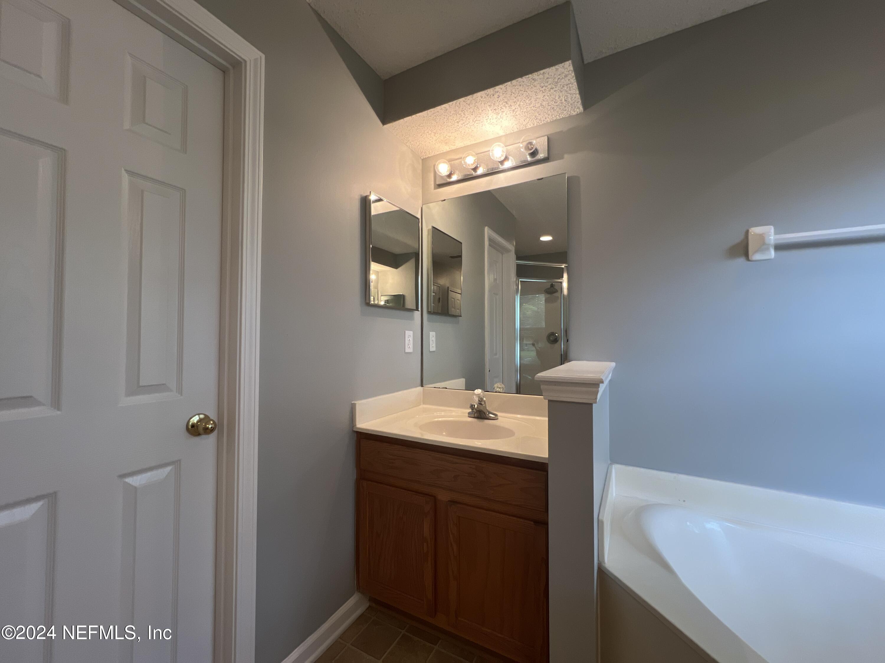 1402 Samantha Circle East Jacksonville, FL 32218 - Photo 20 of 33 a bathroom with a sink and a mirror