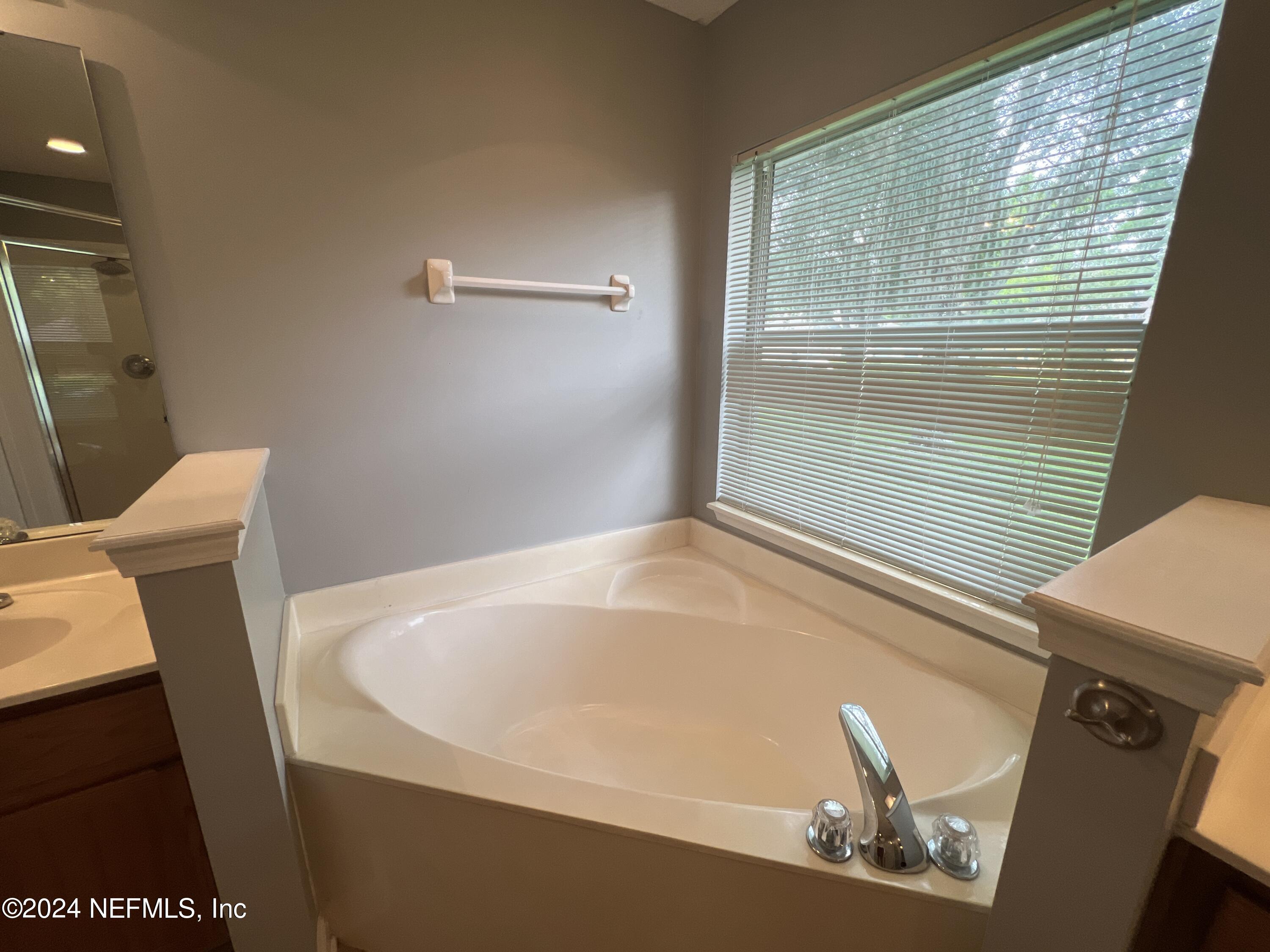 1402 Samantha Circle East Jacksonville, FL 32218 - Photo 21 of 33 a bath tub sitting in a bathroom next to a window