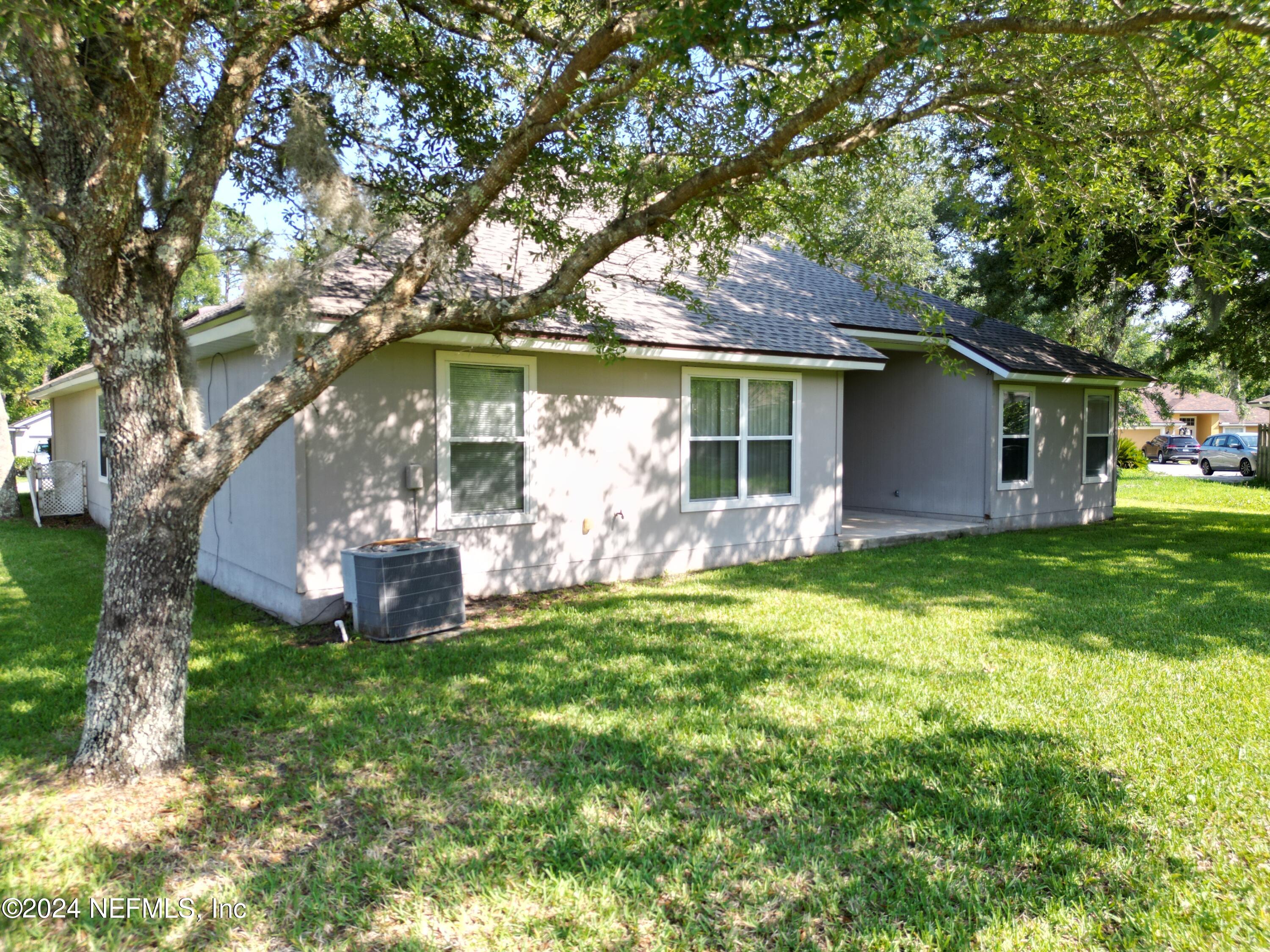 1402 Samantha Circle East Jacksonville, FL 32218 - Photo 31 of 33 a view of a house with a yard and large tree