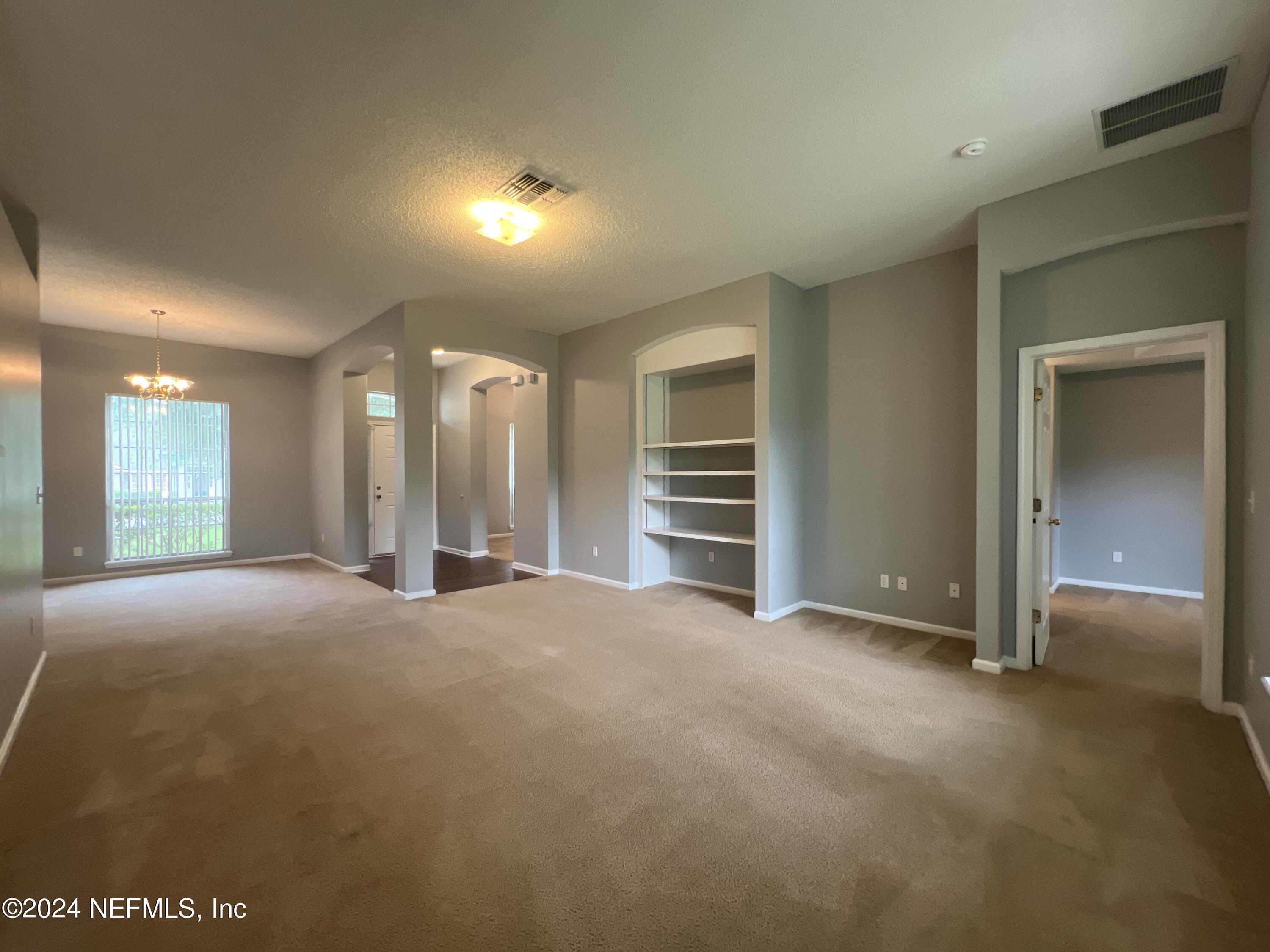 1402 Samantha Circle East Jacksonville, FL 32218 - Photo 10 of 33 a view of an empty room with a fireplace and window