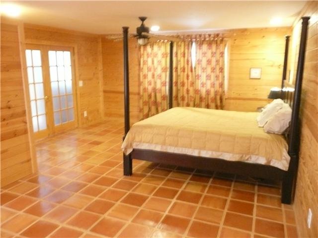 151 Hayes Ridge Road Lancaster, TN 38569 - Photo 3 of 10 Another look at the Master Bedroom...beautiful tile floors and gorgeous wood walls