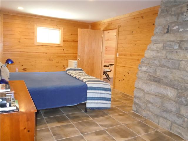 151 Hayes Ridge Road Lancaster, TN 38569 - Photo 4 of 10 2nd bedroom: Stone and wood...what a duo! (Partially plumbed for 2nd bath too)