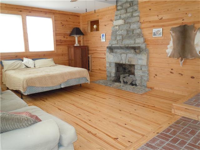 151 Hayes Ridge Road Lancaster, TN 38569 - Photo 5 of 10 Enormous 3rd bedroom complete with original stone fireplace and enough space for sofas and chairs!