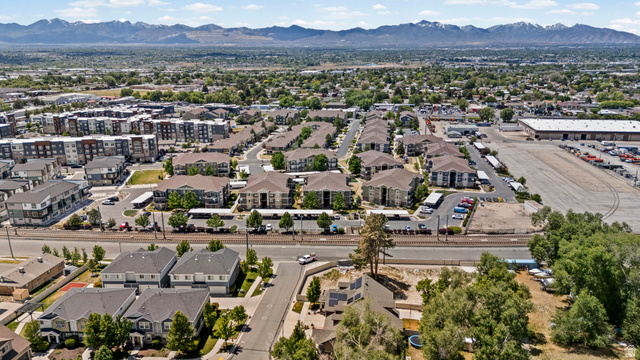 8248 South Resaca Drive, Unit J10 Sandy, UT 84070 - Photo 39 of 40 Expansive aerial perspective showcasing a residential community with multi-story apartment buildings and single-family residences