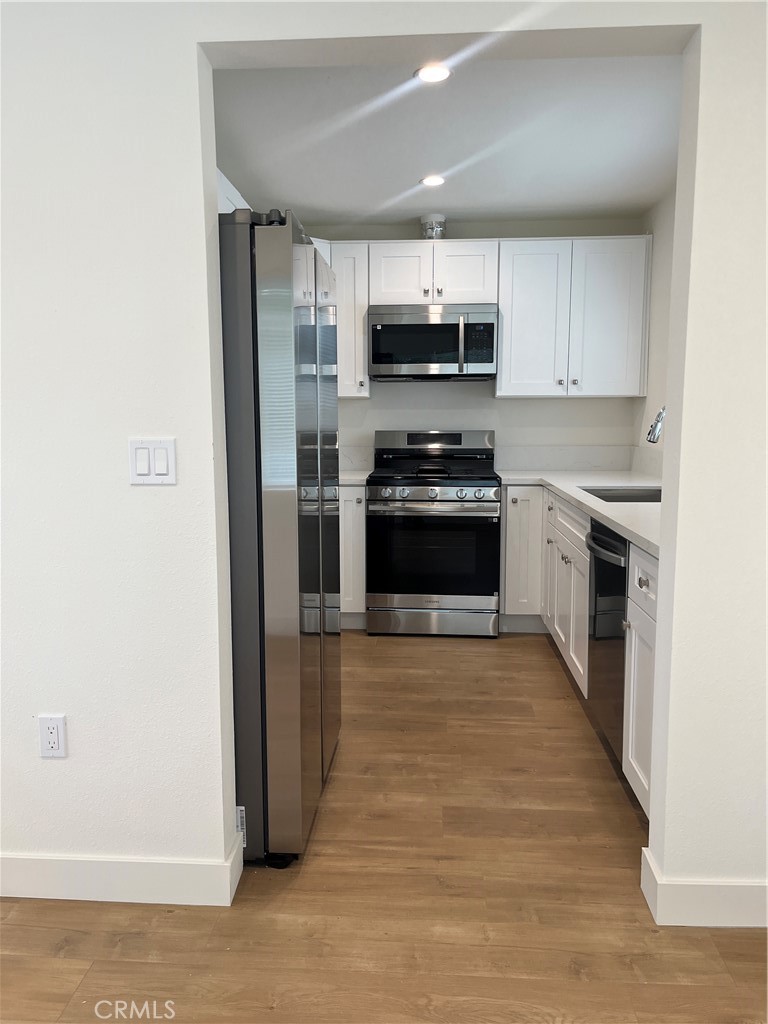 1011 East Chevy Chase Drive, Unit B Glendale, CA 91205 - Photo 4 of 11 a kitchen with stainless steel appliances a stove refrigerator sink and cabinets