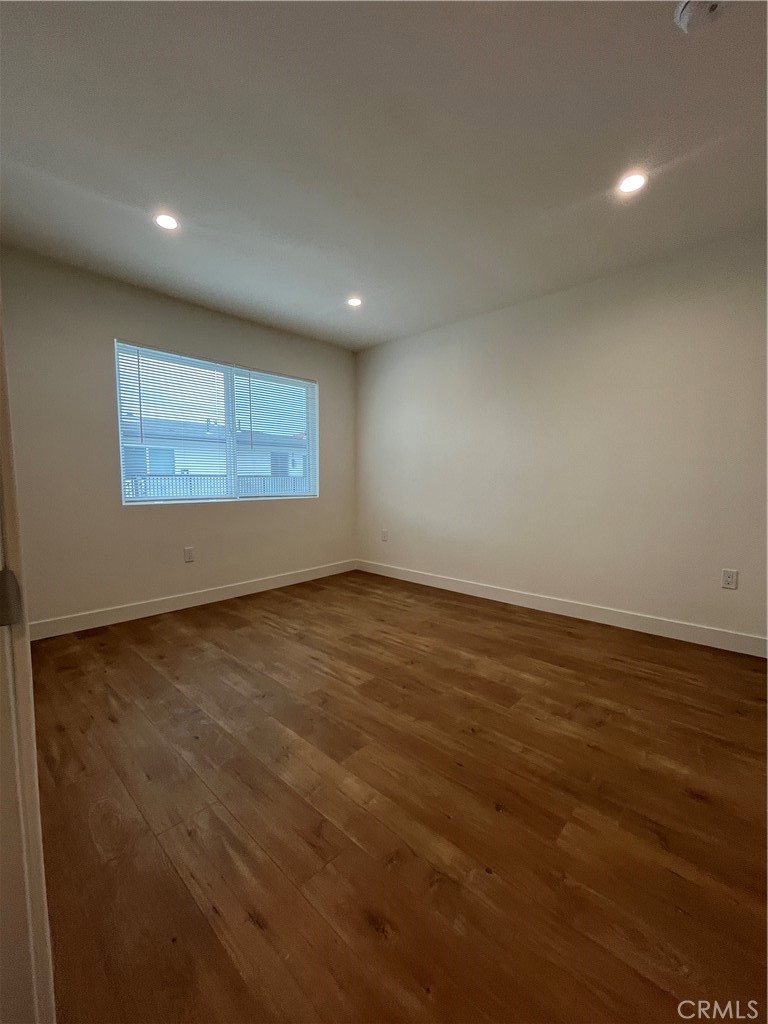 1011 East Chevy Chase Drive, Unit B Glendale, CA 91205 - Photo 9 of 11 an empty room with wooden floor and windows
