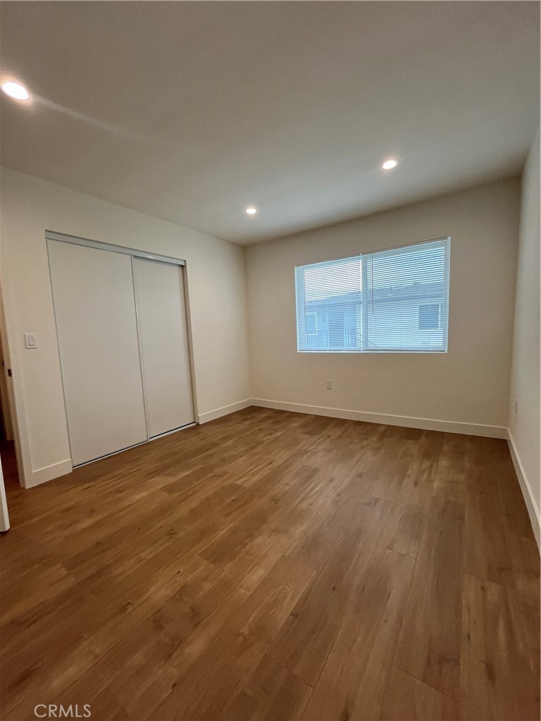 1011 East Chevy Chase Drive, Unit B Glendale, CA 91205 - Photo 10 of 11 an empty room with wooden floor and windows