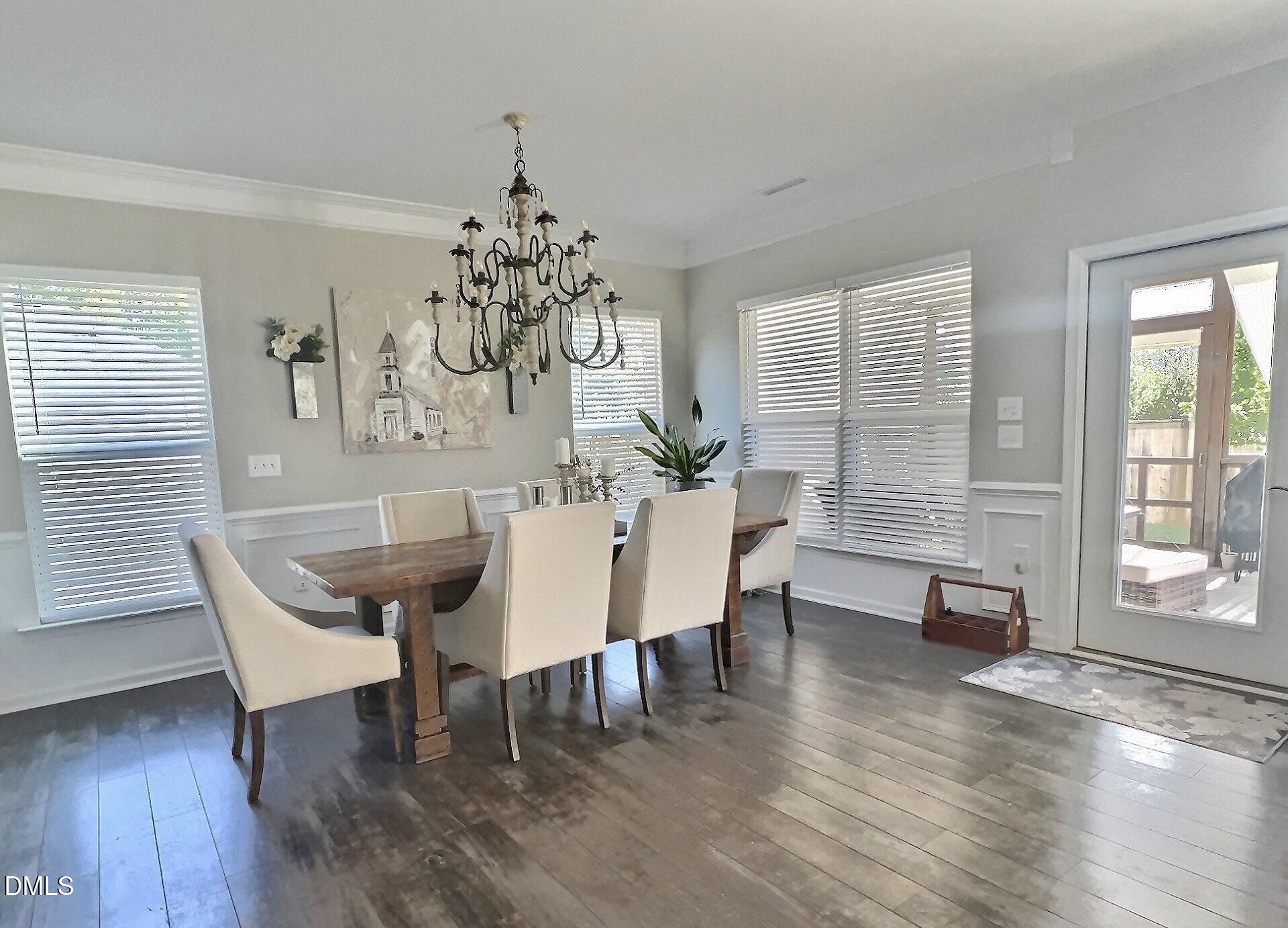 236 Oakmere Drive Cary, NC 27513 - Photo 12 of 49 a view of a dining room with furniture wooden floor and chandelier