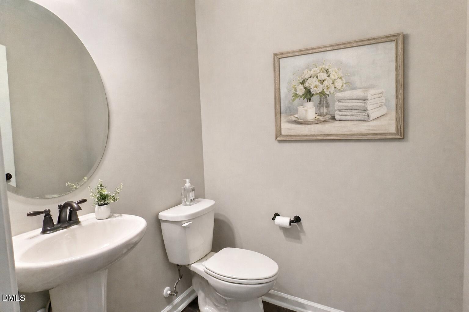 236 Oakmere Drive Cary, NC 27513 - Photo 17 of 49 a bathroom with a toilet a sink and a mirror