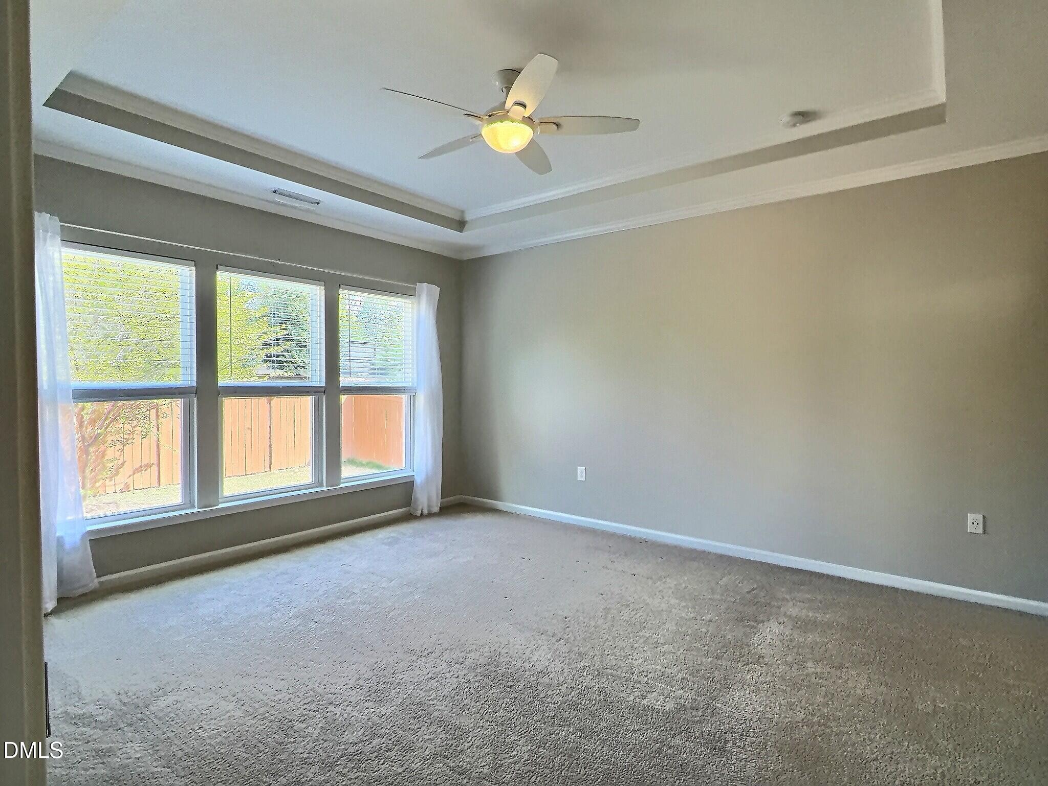 236 Oakmere Drive Cary, NC 27513 - Photo 19 of 49 an empty room with a window and a ceiling fan