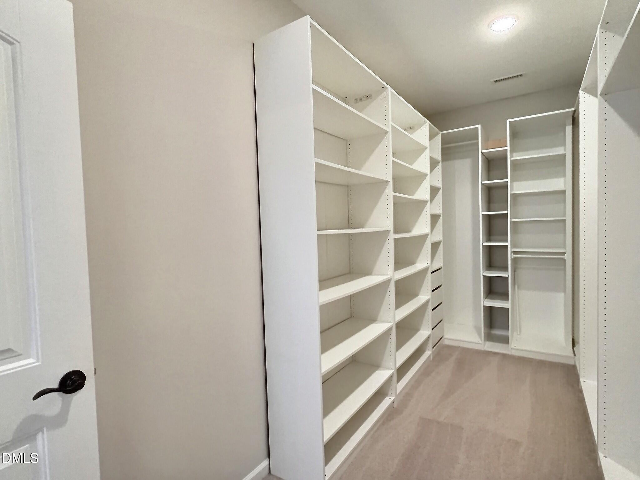 236 Oakmere Drive Cary, NC 27513 - Photo 24 of 49 a view of walk in closet with empty racks