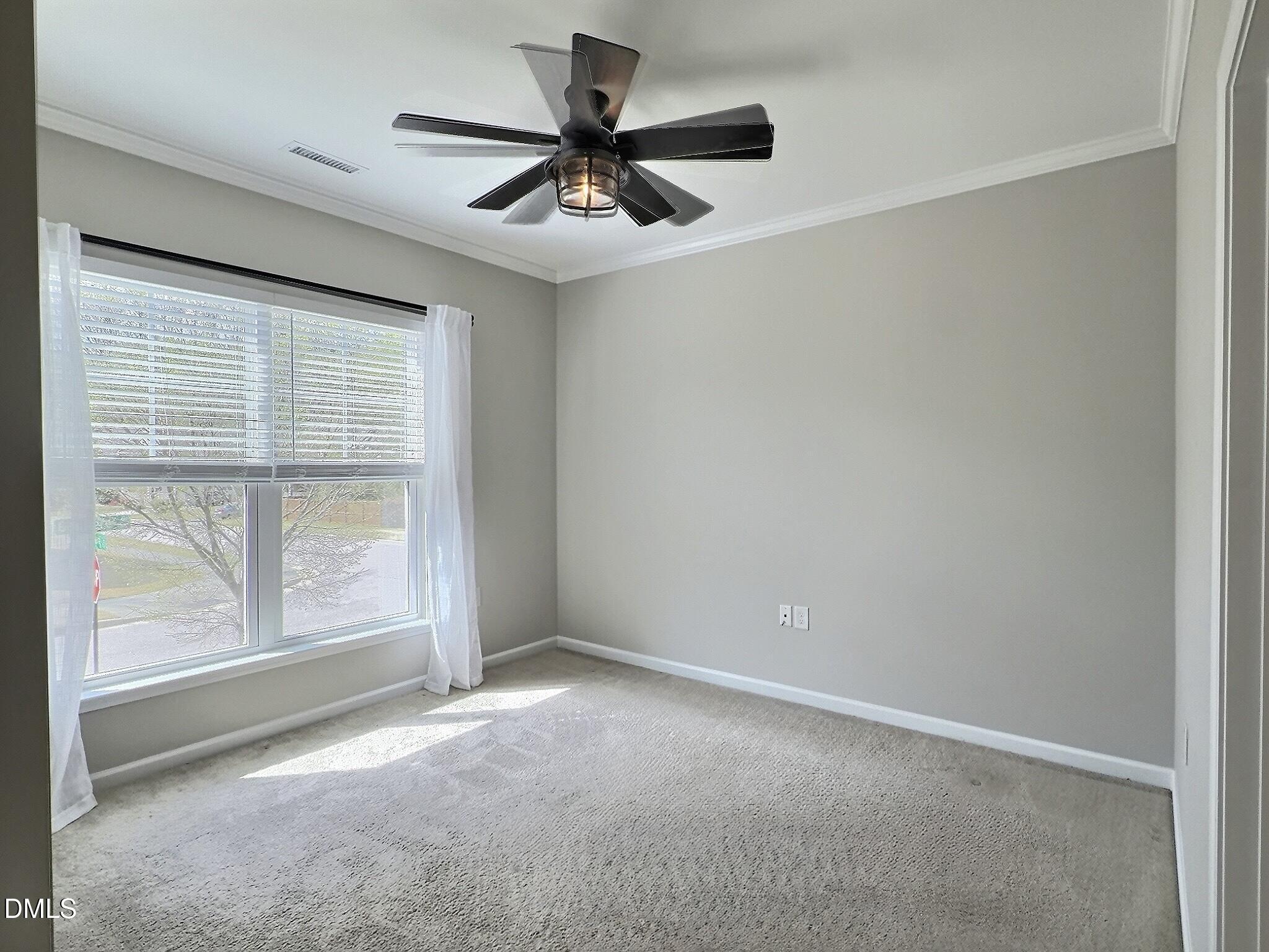 236 Oakmere Drive Cary, NC 27513 - Photo 28 of 49 an empty room with a ceiling fan and windows