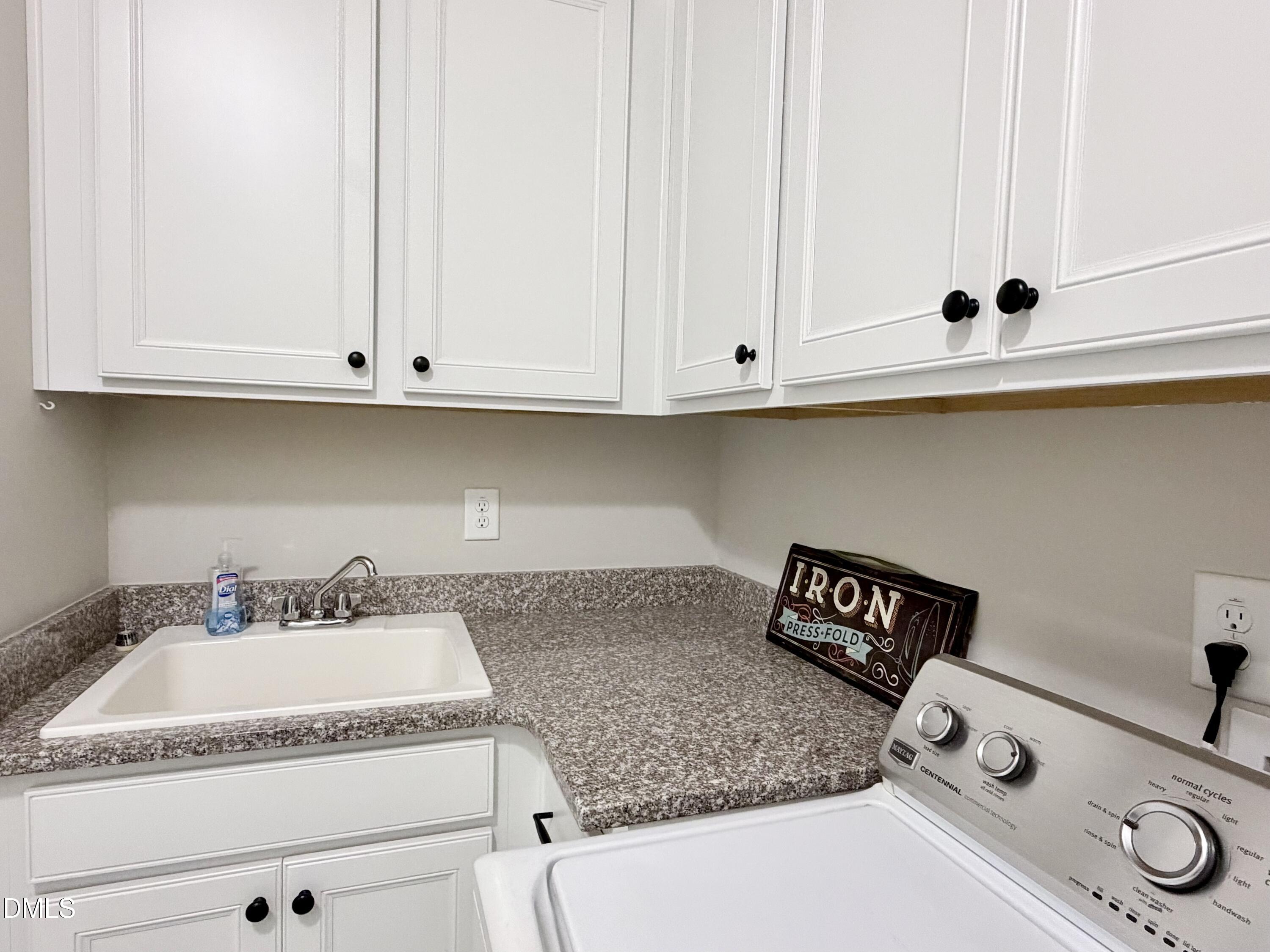 236 Oakmere Drive Cary, NC 27513 - Photo 34 of 49 a kitchen with a sink and cabinets