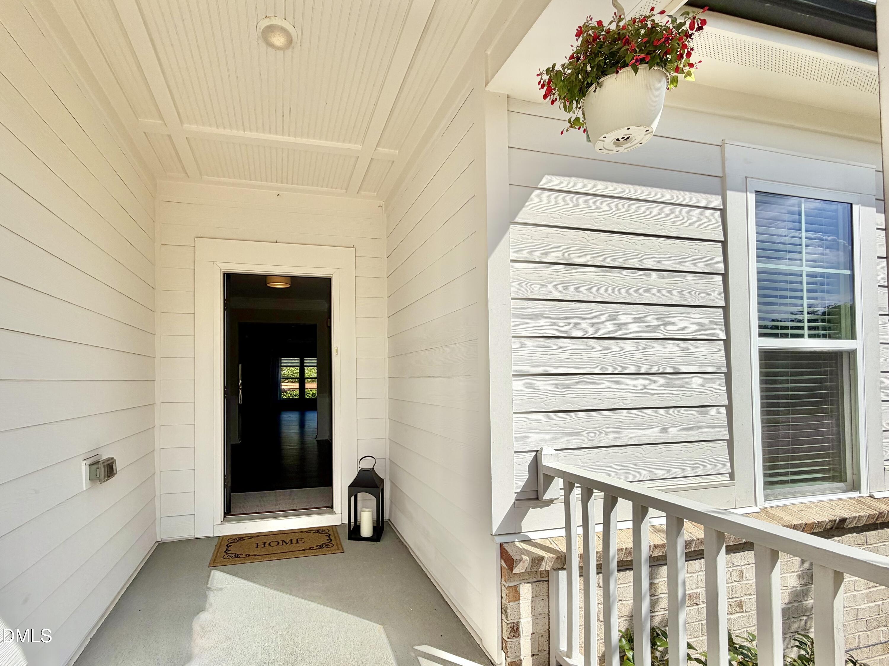 236 Oakmere Drive Cary, NC 27513 - Photo 3 of 49 a view of a house with a door and wooden bench