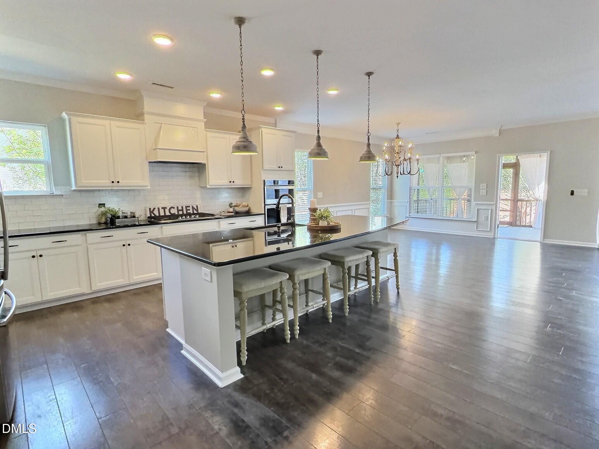 236 Oakmere Drive Cary, NC 27513 - Photo 7 of 49 a kitchen with stainless steel appliances granite countertop a stove and a wooden floors
