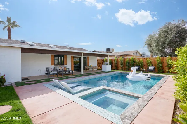 a view of a house with swimming pool and sitting area
