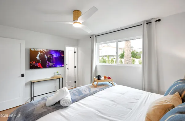 a bedroom with two beds and a chandelier