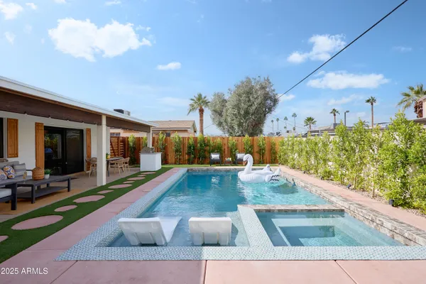 a view of a swimming pool with outdoor seating