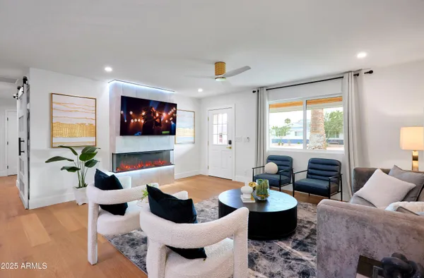a living room with furniture and a flat screen tv