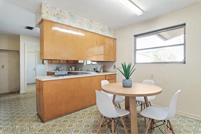 a kitchen with a sink stove and cabinets