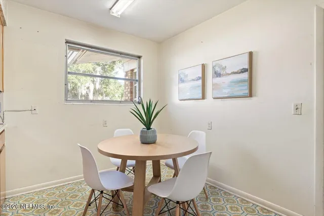 a kitchen with a sink window and cabinets