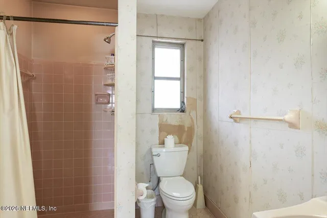 a bathroom with a double vanity sink mirror and shower