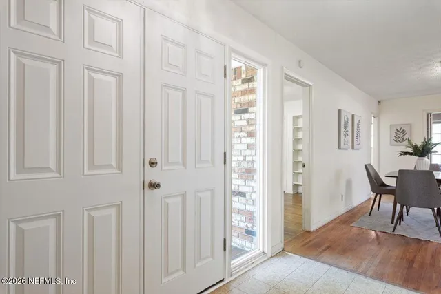 a view of a small space with wooden floor and a window