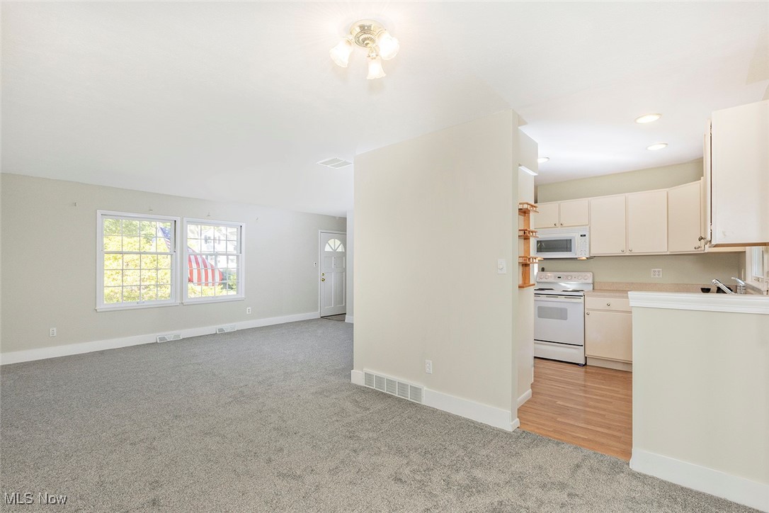 1691 Harwich Road Lyndhurst, OH 44124 - Photo 14 of 45 Unfurnished living room with light colored carpet and recessed lighting