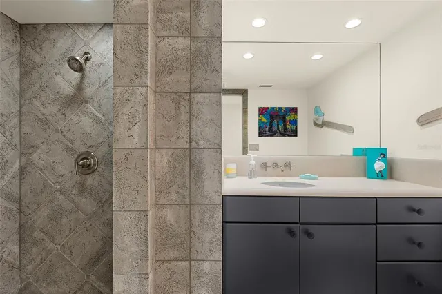 a bathroom with a double vanity sink a mirror and shower