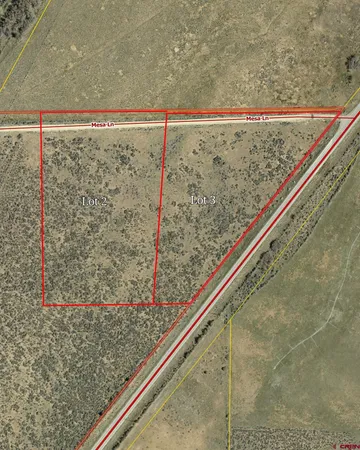 a close up of a road with a dry ground in the background