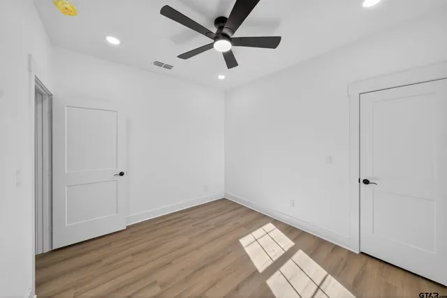 a white toilet sitting next to a shower