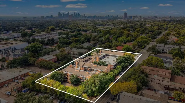 a view of empty room with wooden floor and windows
