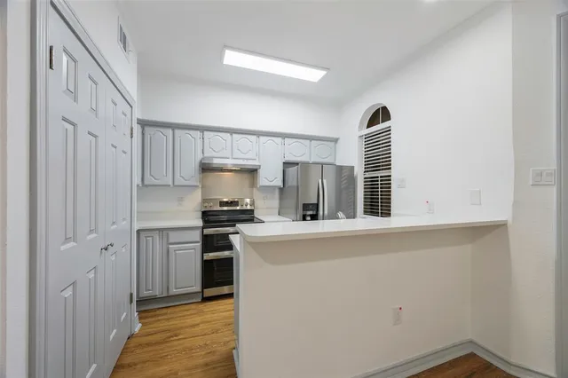 a kitchen with a sink stove and cabinets