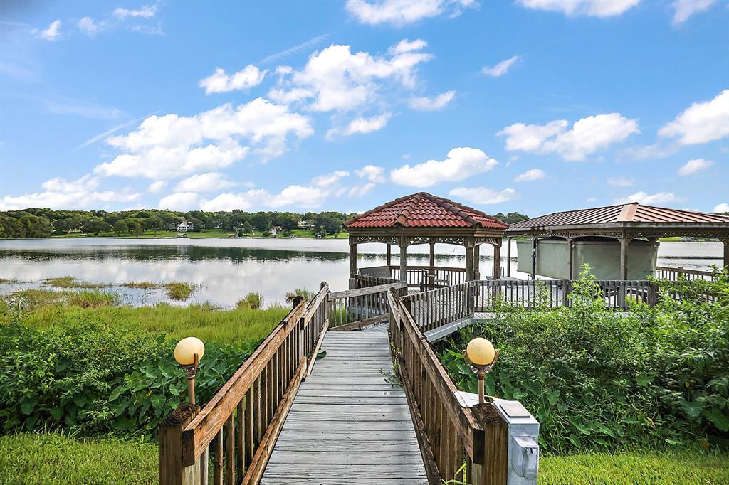 2701 Regal Point Place Eustis, FL 32726 - Photo 16 of 53 a view of a lake with a garden