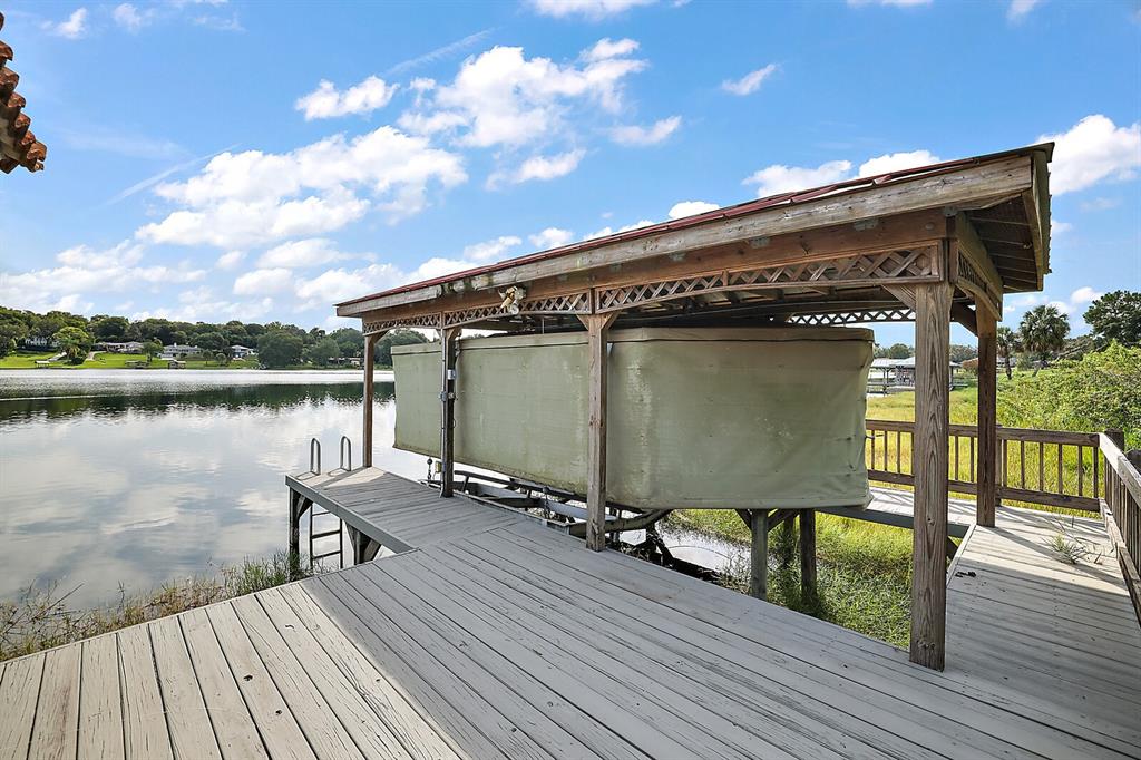 2701 Regal Point Place Eustis, FL 32726 - Photo 17 of 53 a view of a wooden deck with lake view