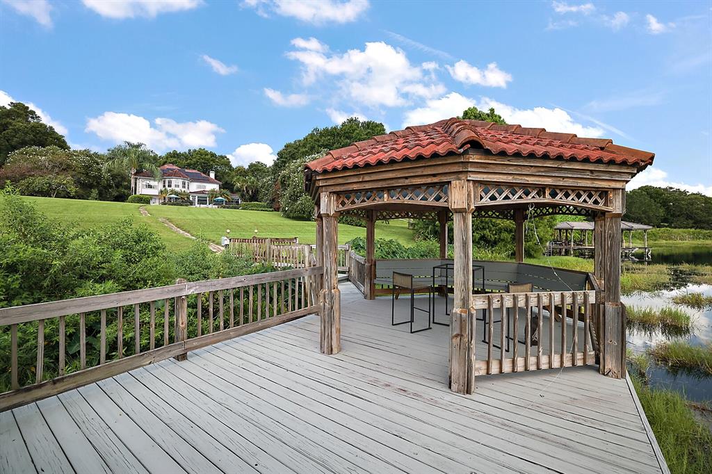 2701 Regal Point Place Eustis, FL 32726 - Photo 20 of 53 a view of a deck with a table and chairs