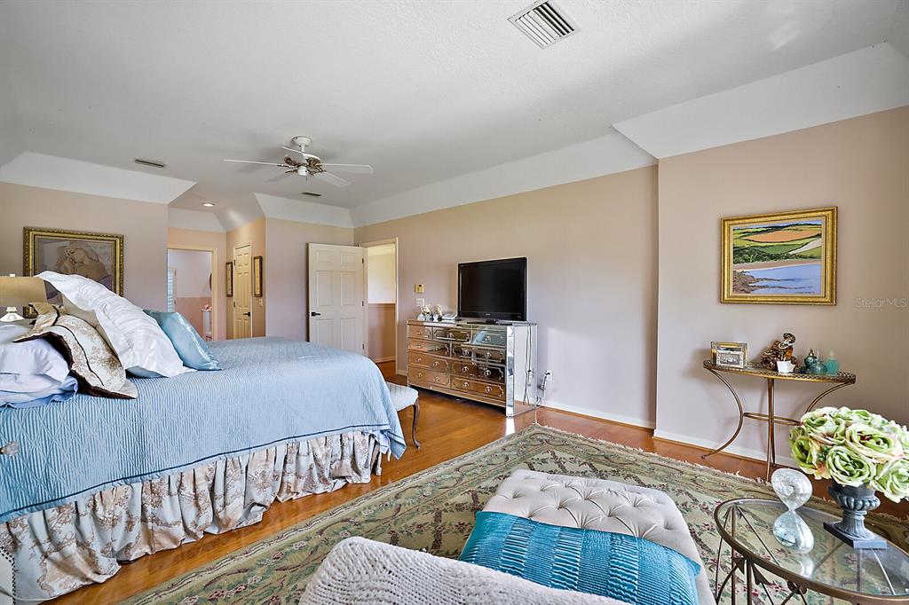 2701 Regal Point Place Eustis, FL 32726 - Photo 26 of 53 a bedroom with a bed a couch and dresser