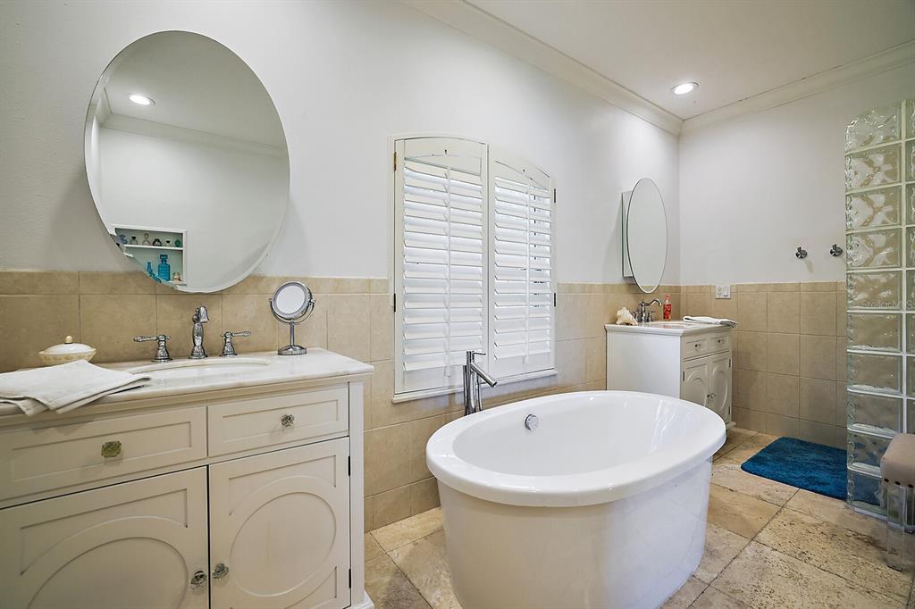 2701 Regal Point Place Eustis, FL 32726 - Photo 28 of 53 a spacious bathroom with a sink a mirror a toilet and a tub