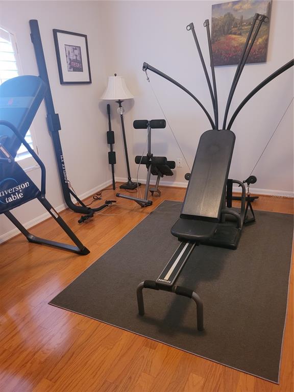 2701 Regal Point Place Eustis, FL 32726 - Photo 32 of 53 a room with gym equipment and wooden floor
