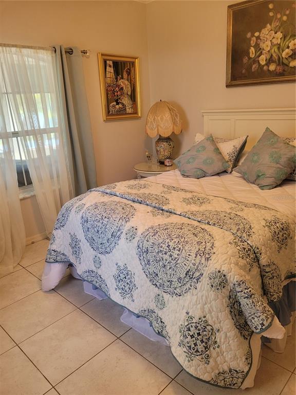 2701 Regal Point Place Eustis, FL 32726 - Photo 35 of 53 a bedroom with a bed and wooden floor