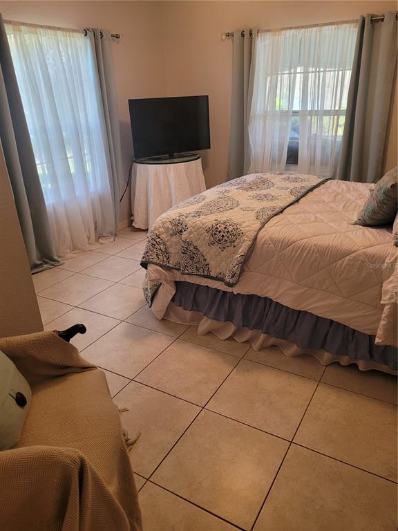 2701 Regal Point Place Eustis, FL 32726 - Photo 36 of 53 a bedroom with a bed and a flat screen tv