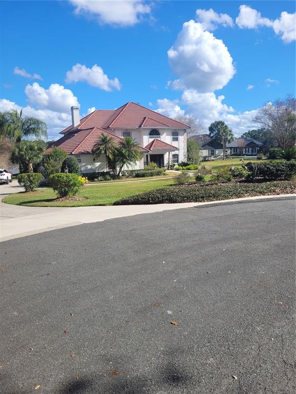 2701 Regal Point Place Eustis, FL 32726 - Photo 4 of 53 a view of a house with a yard and potted plants