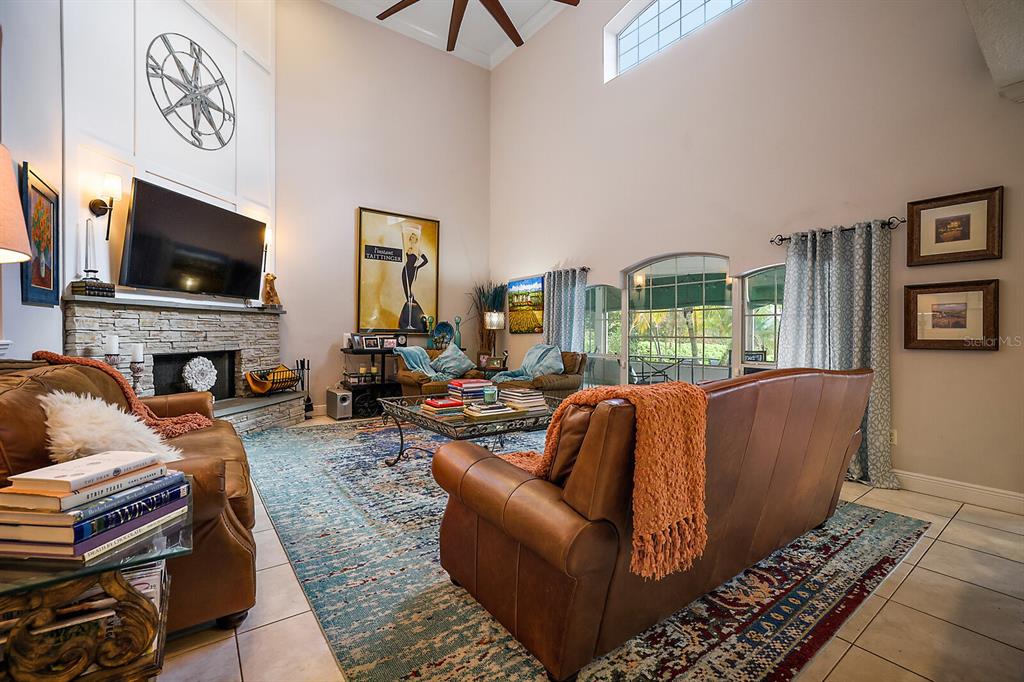 2701 Regal Point Place Eustis, FL 32726 - Photo 41 of 53 a living room with furniture a flat screen tv and a fireplace