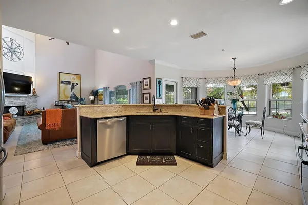 a dining room with furniture a chandelier and wooden floor