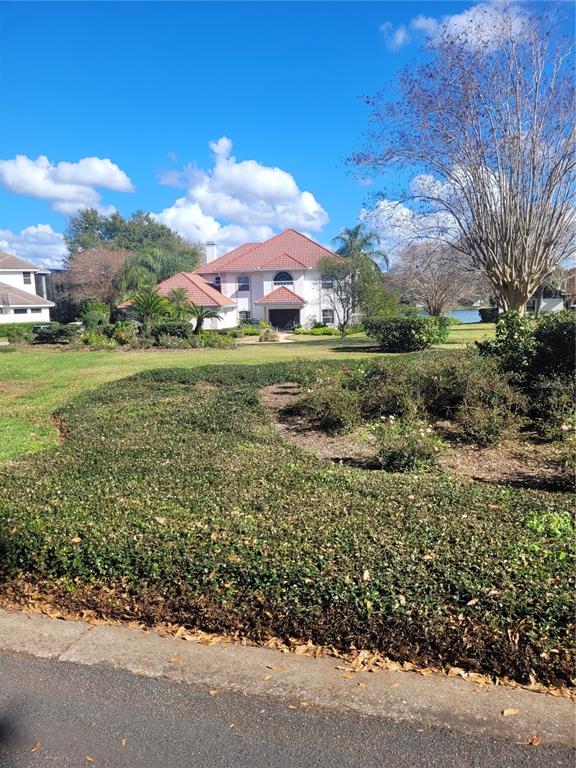 2701 Regal Point Place Eustis, FL 32726 - Photo 7 of 53 a view of a garden with a building in the background