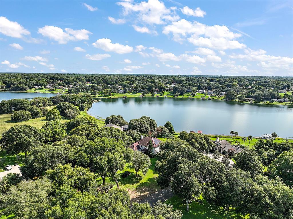 2701 Regal Point Place Eustis, FL 32726 - Photo 10 of 53 a view of a lake with houses in the back